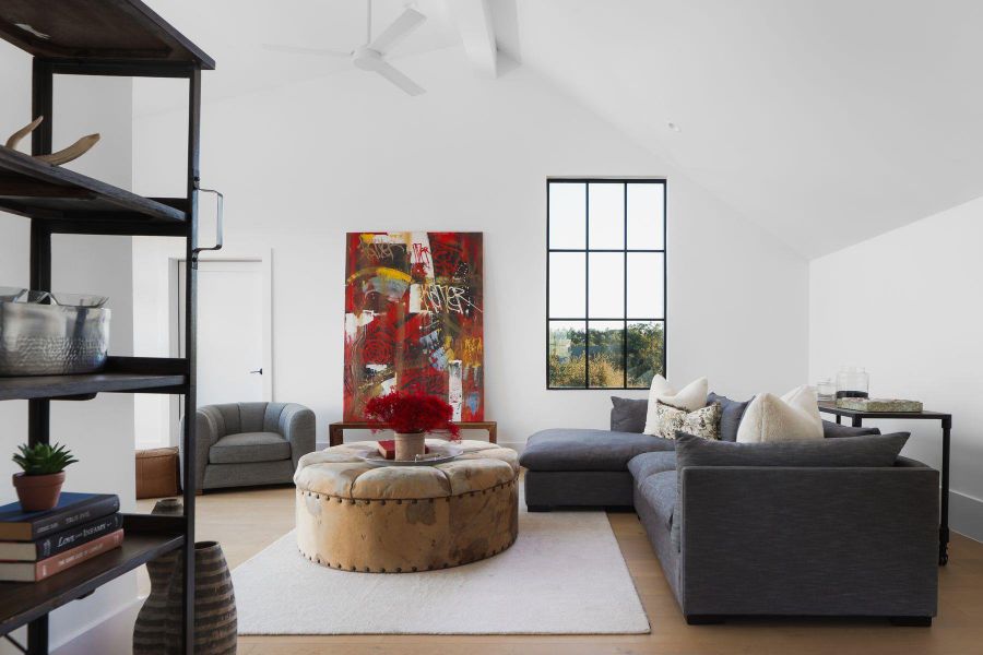 Living room featuring high vaulted ceiling, wood finished floors, beamed ceiling, and a ceiling fan Living room featuring high vaulted ceiling, wood finished floors, beamed ceiling, and a ceiling fan