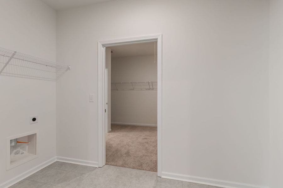 Laundry room with access to the primary walk-in closet. Laundry room with access to the primary walk-in closet.