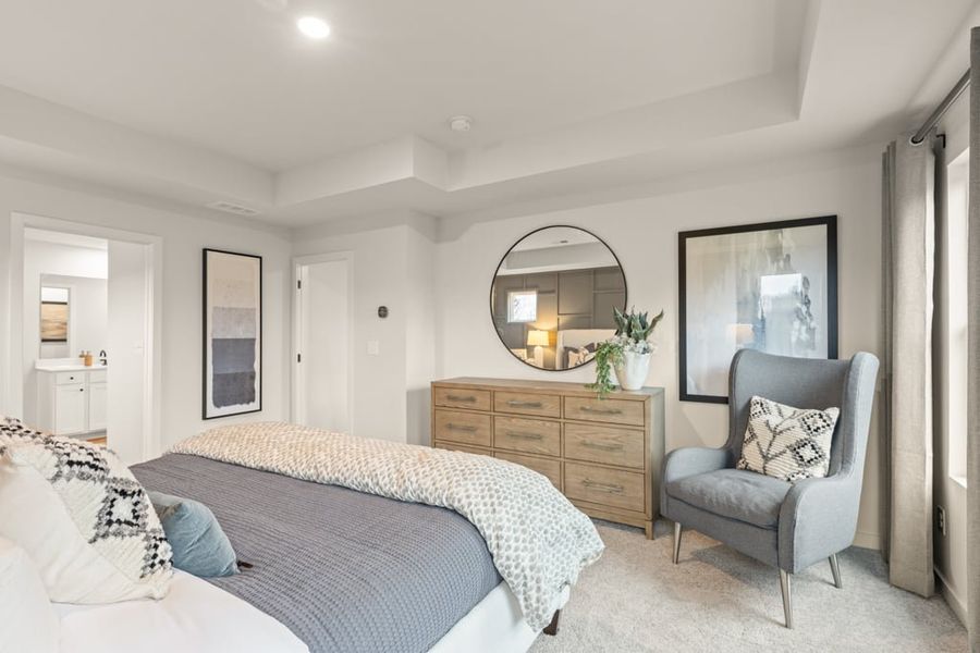 A bedroom with a bed and a chair.