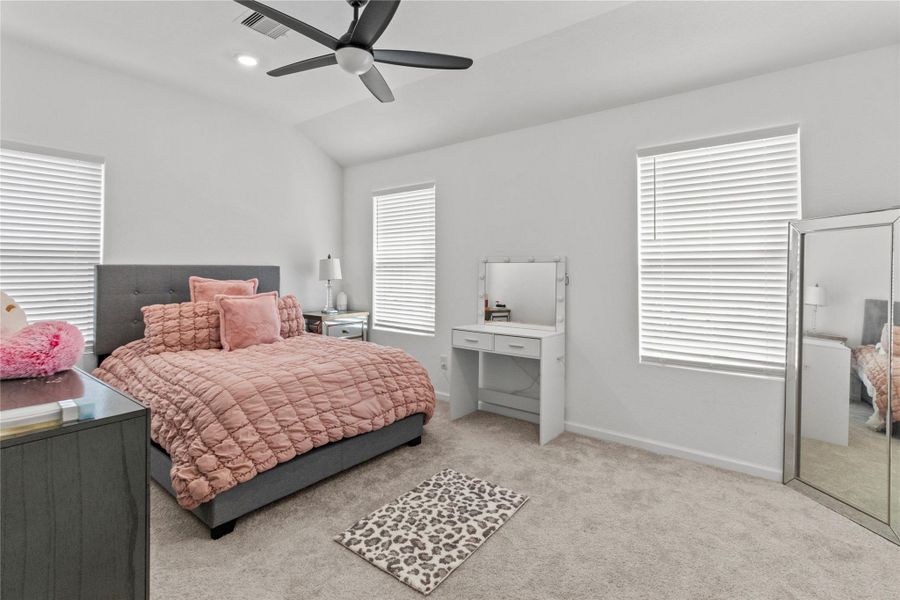 Bright and inviting bedroom with ample natural light from two windows, while the ceiling fan ensures comfort. Bright and inviting bedroom with ample natural light from two windows, while the ceiling fan ensures comfort.