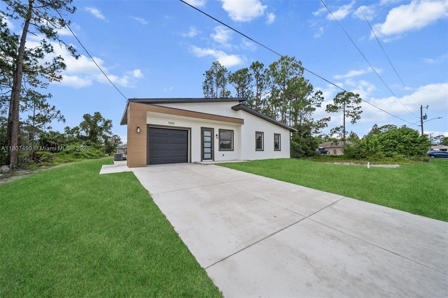 Front exterior of a new home in , Lehigh Acres, FL, highlighting curb appeal (Image 1). Front exterior of a new home in , Lehigh Acres, FL, highlighting curb appeal (Image 1).