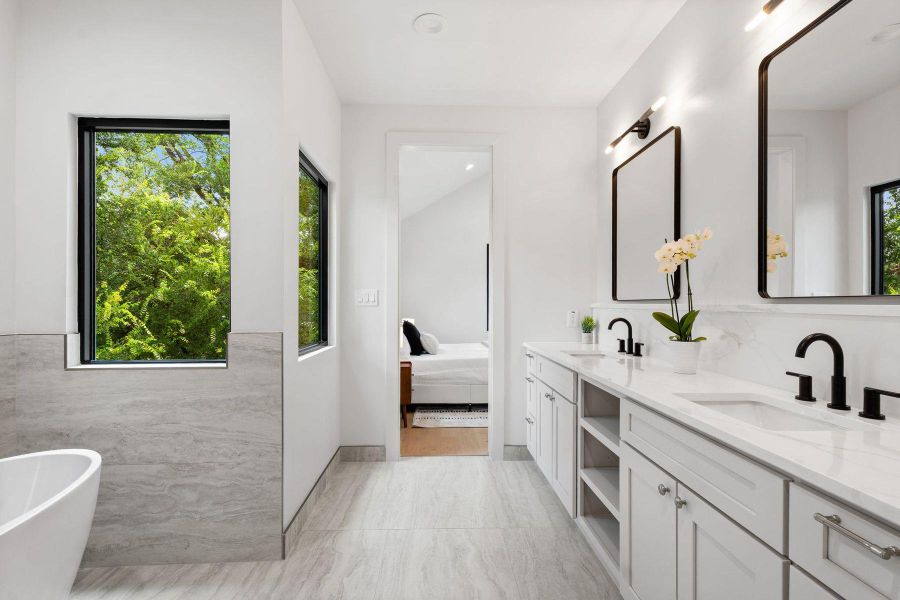 White walls and a dual vanity with rectangular mirrors create a refreshing and modern bathroom. White walls and a dual vanity with rectangular mirrors create a refreshing and modern bathroom.