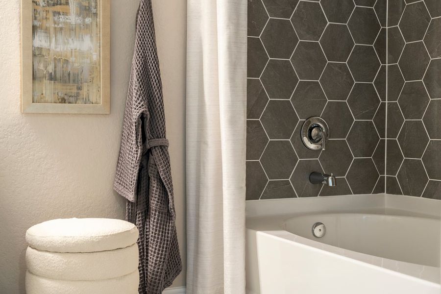 Garden tub with hexagon tile surround at primary bath Garden tub with hexagon tile surround at primary bath