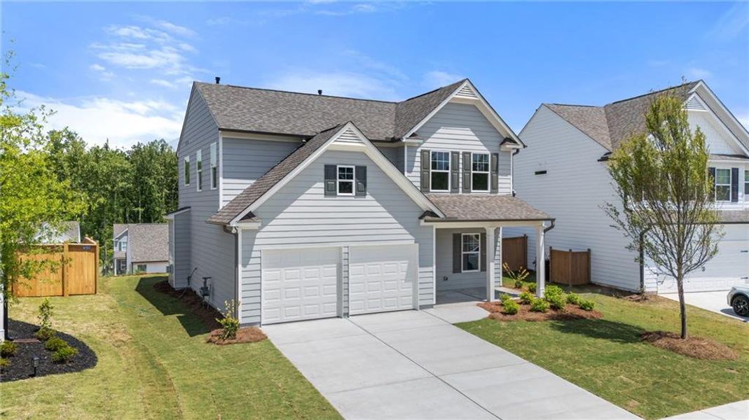 Front exterior of a new home in The Reserve at Willow Oaks, Canton, GA, highlighting curb appeal (Image 2).