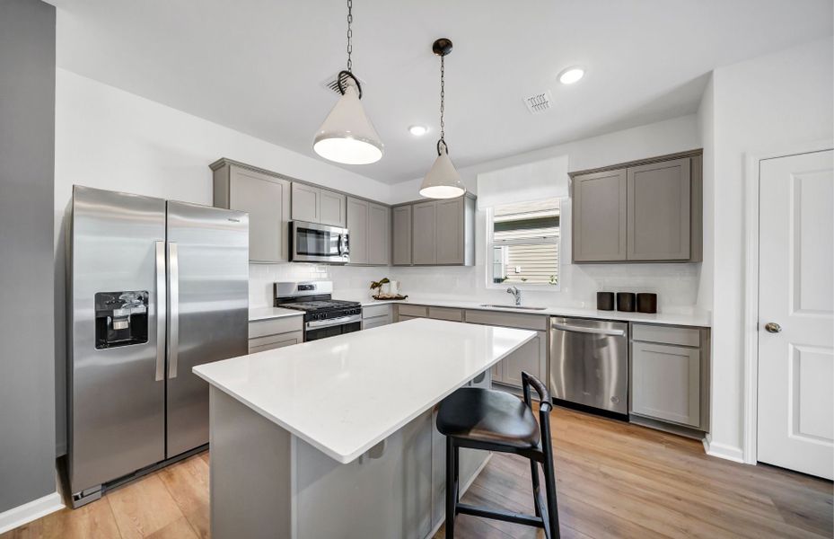 Discover the modern elegance in the kitchen with sleek grey cabinets.