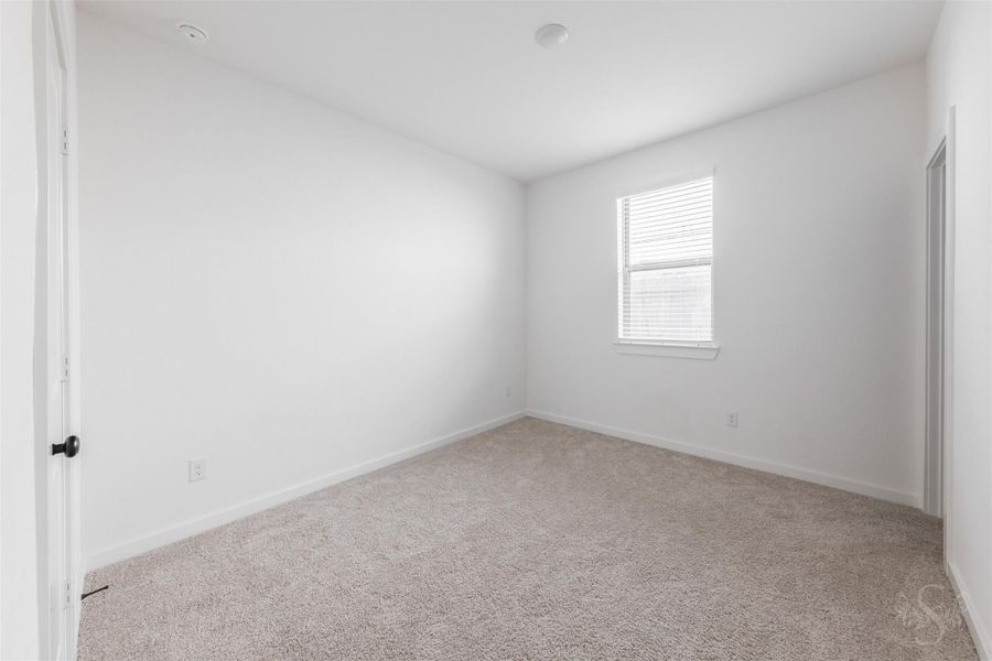 This bright secondary bedroom features soft neutral carpet, a large window for natural light, and a spacious layout that easily accommodates furniture. A versatile space ideal for a guest room, home office, or kids’ retreat. This bright secondary bedroom features soft neutral carpet, a large window for natural light, and a spacious layout that easily accommodates furniture. A versatile space ideal for a guest room, home office, or kids’ retreat.
