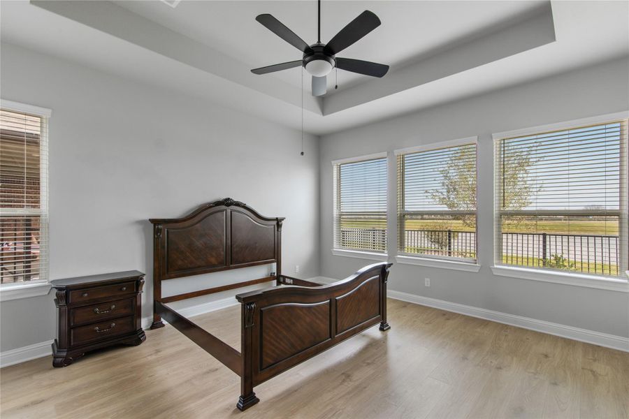 Wake up to stunning water views in this primary bedroom oasis.