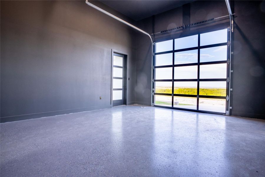 Empty room with a towering ceiling and speckle patterned floor