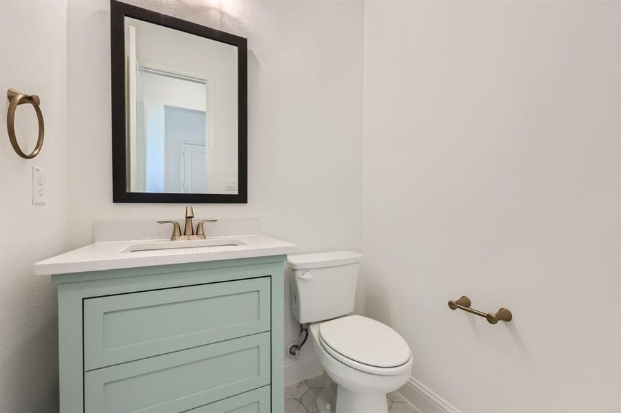 Bathroom with tile patterned floors, toilet, and vanity