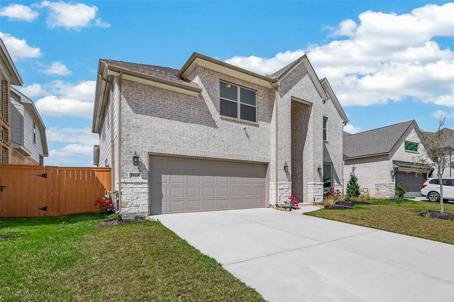 Front exterior of a new home in Sunterra, Katy, TX, highlighting curb appeal (Image 2). Front exterior of a new home in Sunterra, Katy, TX, highlighting curb appeal (Image 2).