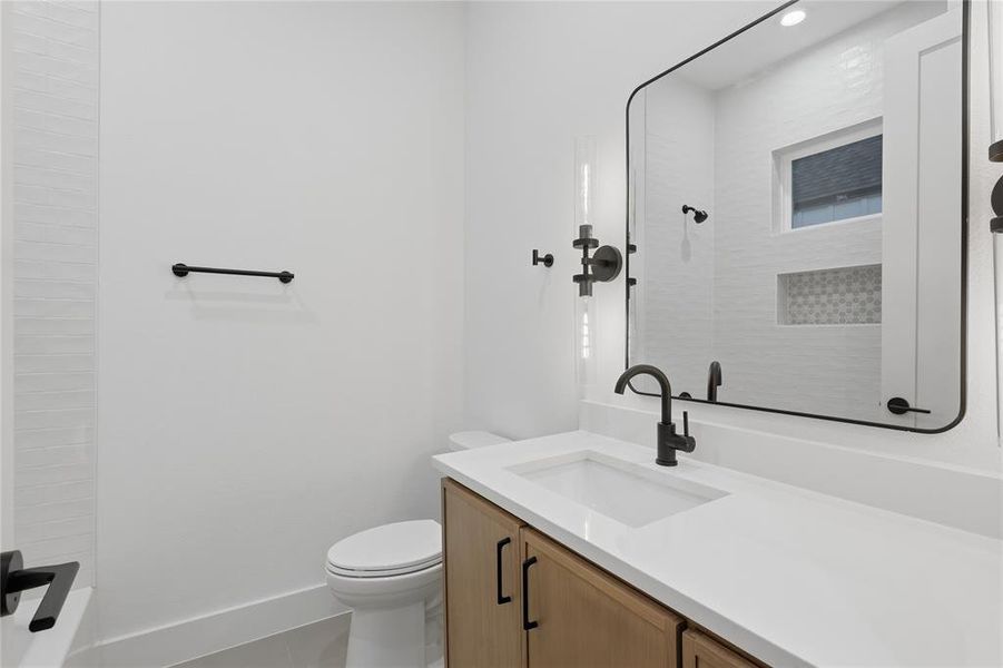 Full bath featuring vanity and toilet