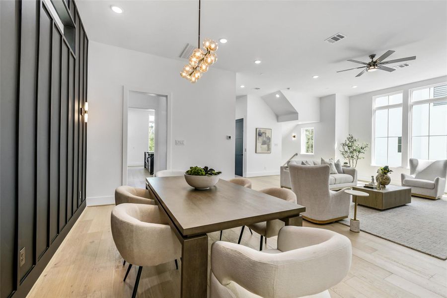 An open-concept layout connects the dining area to the light-filled living room and modern fireplace feature wall. Architectural symmetry, high ceilings, and designer finishes showcase a balance of sophistication and comfort—ideal for entertaining in style. An open-concept layout connects the dining area to the light-filled living room and modern fireplace feature wall. Architectural symmetry, high ceilings, and designer finishes showcase a balance of sophistication and comfort—ideal for entertaining in style.