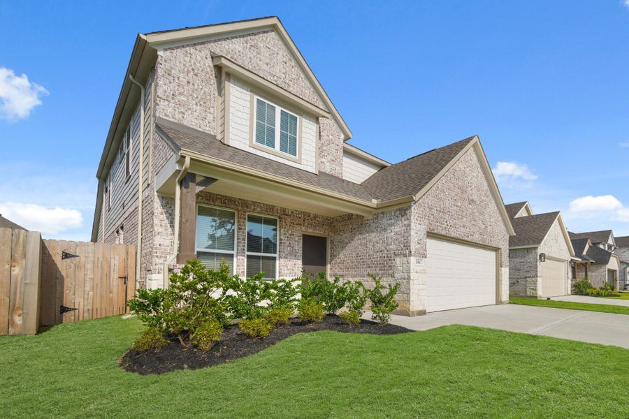 Front exterior of a new home in Barton Creek Ranch, Conroe, TX, highlighting curb appeal (Image 1).