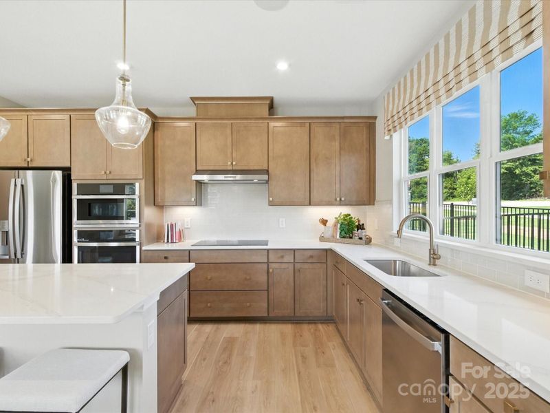 Wood toned cabinetry for a modern look and sleek feel. *Model Photos | Orientation and structural selections may vary. Wood toned cabinetry for a modern look and sleek feel. *Model Photos | Orientation and structural selections may vary.