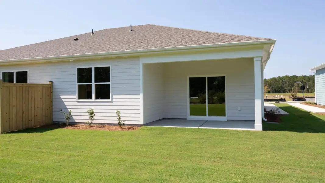 Exterior details and patio area of a home in The Retreat at Indigo Preserve Townhomes, Leland (Image 18).