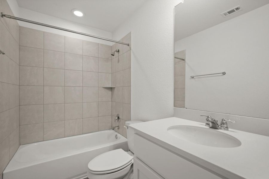 Bathroom with vanity, shower / bath combination, and recessed lighting