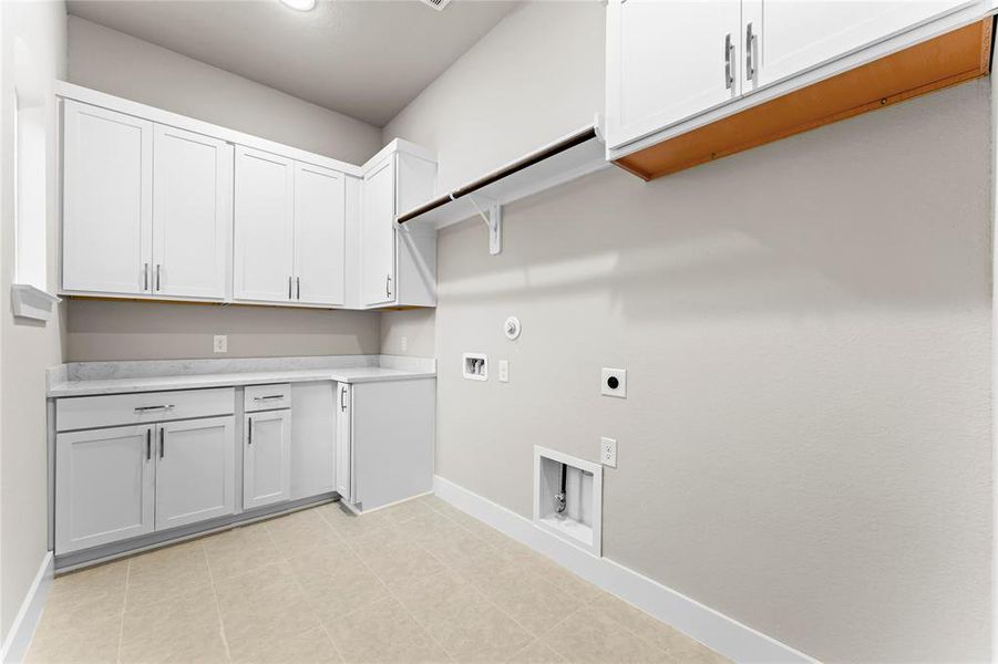 Utility Room with Washer and Dryer Connections, Hanging Bar, Folding Area, and Great Storage!