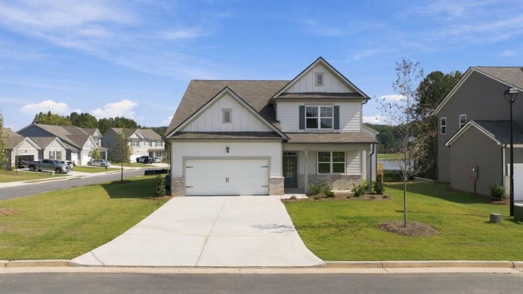Front exterior of a new home in Fairway 17 at Mirror Lake, Villa Rica, GA, highlighting curb appeal (Image 2). Front exterior of a new home in Fairway 17 at Mirror Lake, Villa Rica, GA, highlighting curb appeal (Image 2).