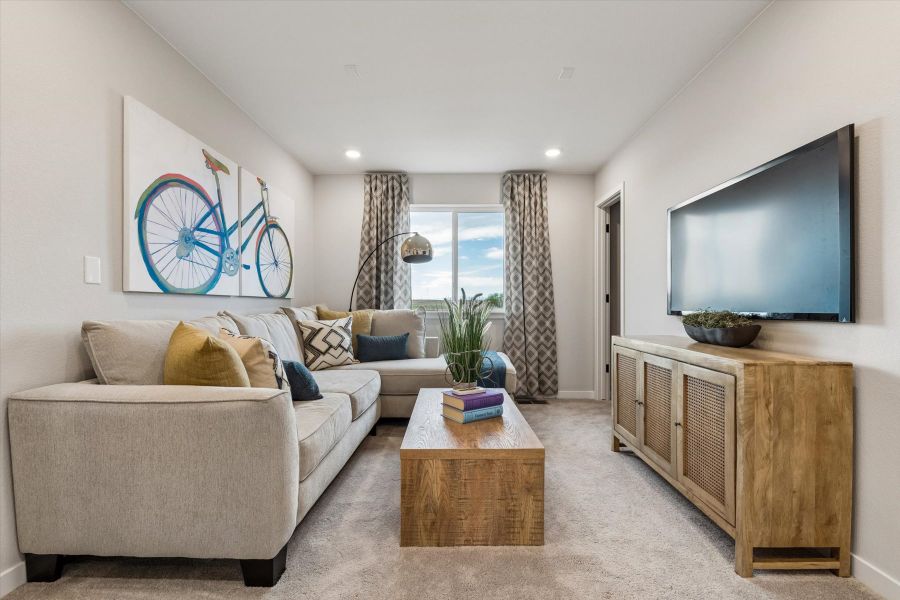 A living room with a couch and a tv. A living room with a couch and a tv.