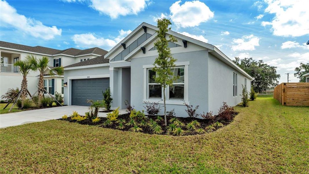 Front exterior of a new home in Timber Ridge, Plant City, FL, highlighting curb appeal (Image 24).