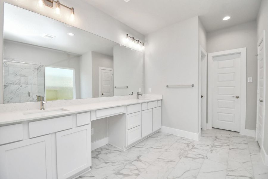 Escape to a spa-like oasis in this primary bathroom. Enjoy a walk-in shower with tile surround, a separate garden tub with custom detailing, and an elegant vanity featuring light countertops, modern hardware, and beautiful recessed lights. Experience luxury and relaxation in every detail. Escape to a spa-like oasis in this primary bathroom. Enjoy a walk-in shower with tile surround, a separate garden tub with custom detailing, and an elegant vanity featuring light countertops, modern hardware, and beautiful recessed lights. Experience luxury and relaxation in every detail.