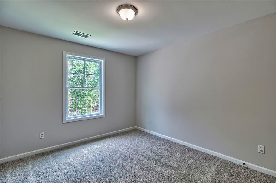 This cozy room offers soft carpeting and a window