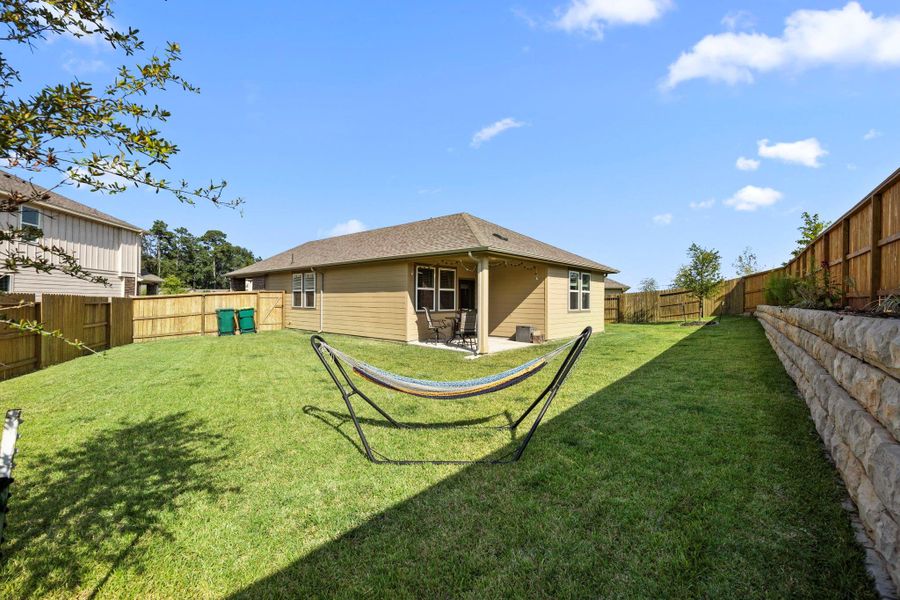 The large, fully stained fenced backyard offers a great space for outdoor activities and is perfect for pets, play, or simply relaxing on a weekend afternoon.