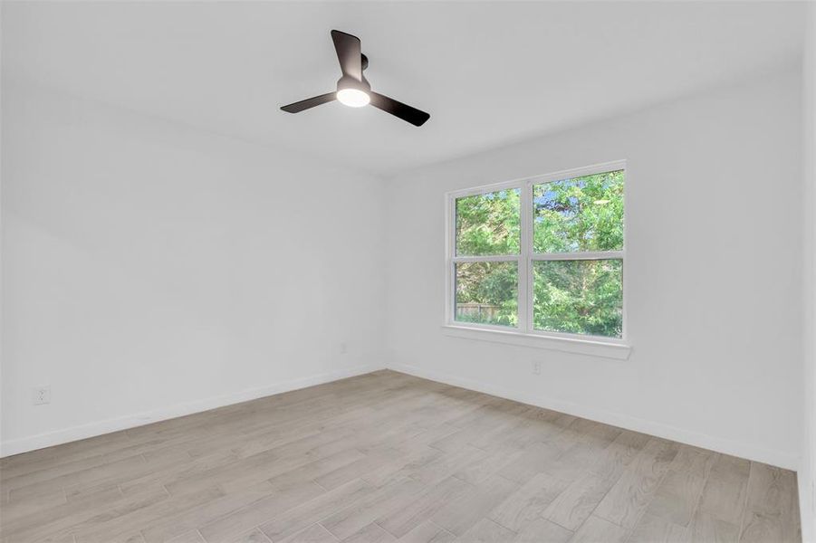 Spare room featuring ceiling fan and light wood finished floors