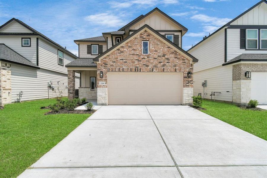 Home showcases a convenient 2-car garage paired with a spacious driveway, providing ample room for parking.