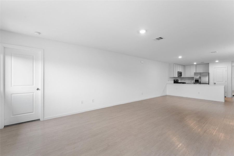 Primary bedroom sits privately off the corner of the living area for a more tucked-away feel.