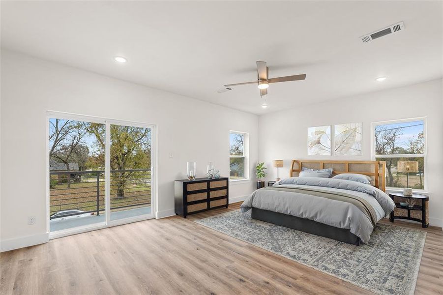 Bedroom featuring access to outside, recessed lighting, light wood-style floors, a ceiling fan, and multiple windows