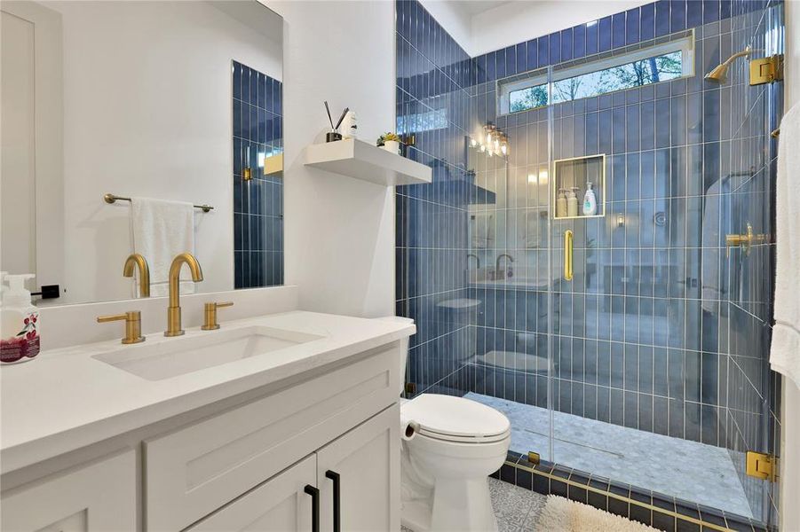 LOVE the blue tiles and gold fixtures! What personality and class! Bath #2 is impressive!@ Located to the right of kitchen.