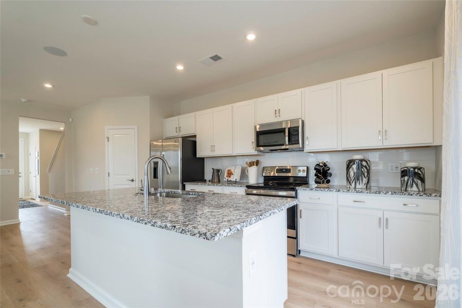Kitchen with white cabinets and granite countertops