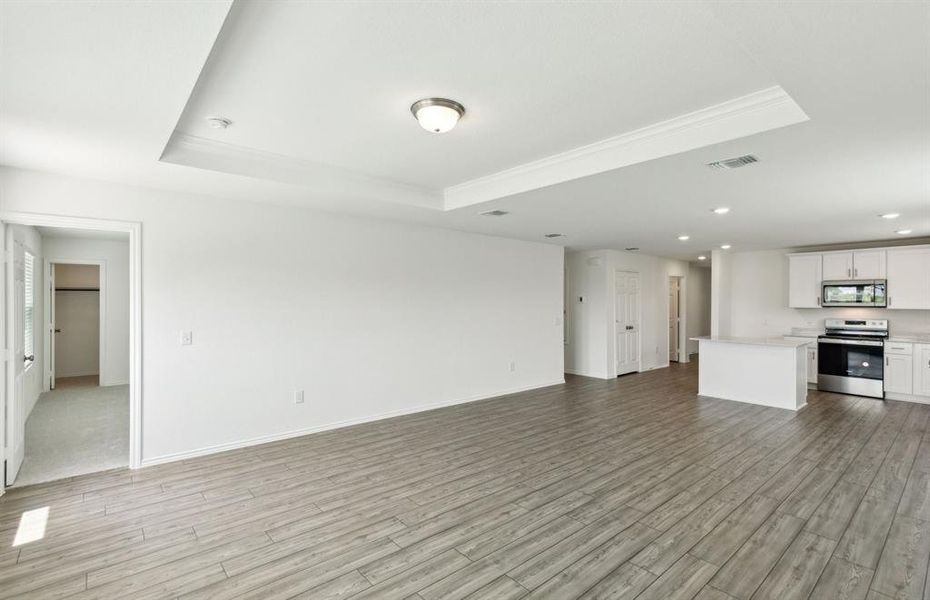 Bright gathering room with tray ceiling *real home pictured