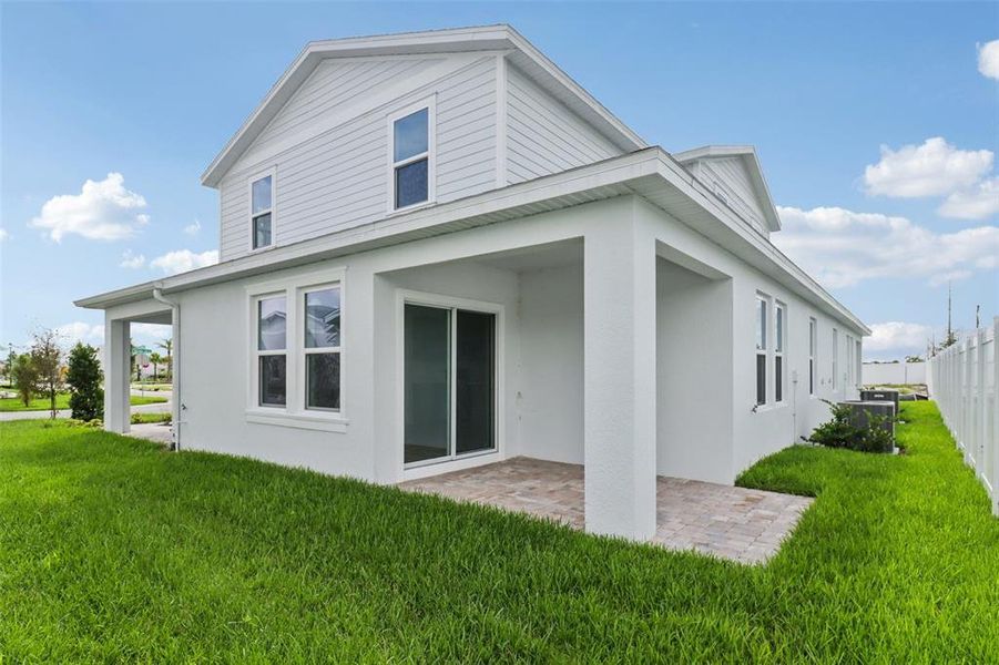 Front exterior of a new home in Cyrene at Harmony, St. Cloud, FL, highlighting curb appeal (Image 1).