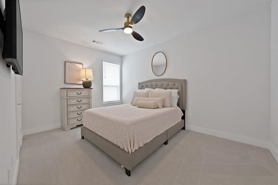 Carpeted room featuring a ceiling fan with integrated lighting, a window with horizontal blinds, and white baseboards Carpeted room featuring a ceiling fan with integrated lighting, a window with horizontal blinds, and white baseboards