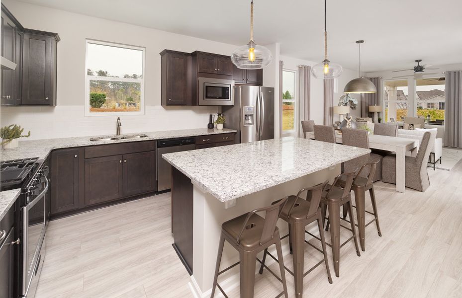 Gourmet Kitchen area with a window above the sink, beautiful countertops, and a large island.