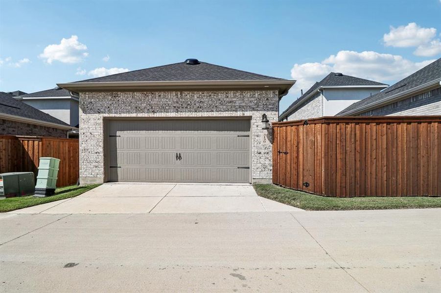 Garage featuring concrete driveway Garage featuring concrete driveway