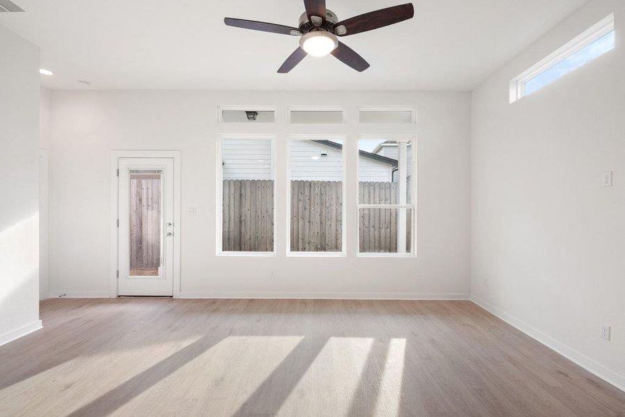 Unfurnished room featuring ceiling fan and light wood-style floors