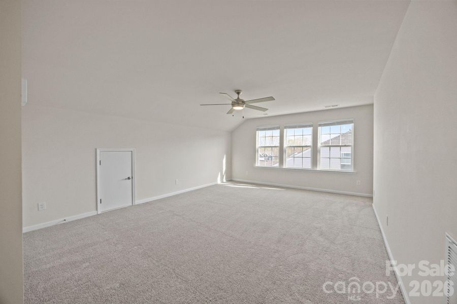 UPSTAIRS LIVING!  Bright, large BONUS space for anything you wish! Several small attic nooks, a large storage closet on other end of room AND a VERY large utility/Storage walk-in closet room!  This leads to UPSTAIRS  BATH AND BEDROOM.