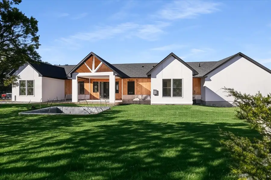 Back of house with a patio, a yard, and stucco siding along with pool. This photo has been Ai Enhanced.