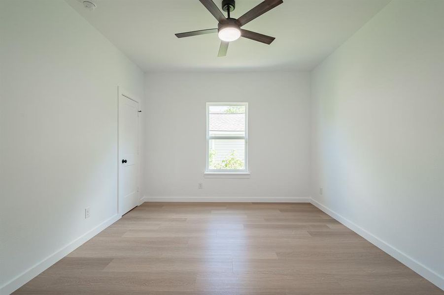 Spare room with ceiling fan and light wood-style floors Spare room with ceiling fan and light wood-style floors