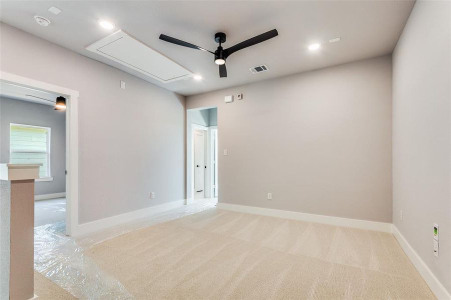 Carpeted empty room with ceiling fan