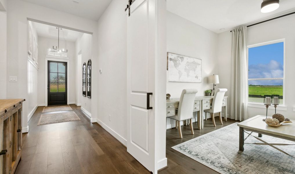 Welcoming foyer with home office featuring double barn doors