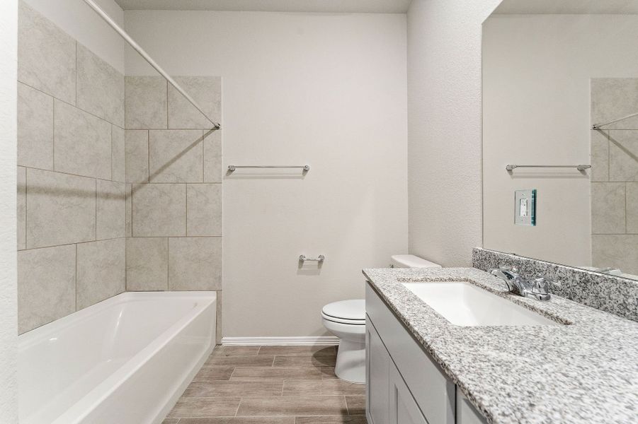 A bathroom with a marble countertop.