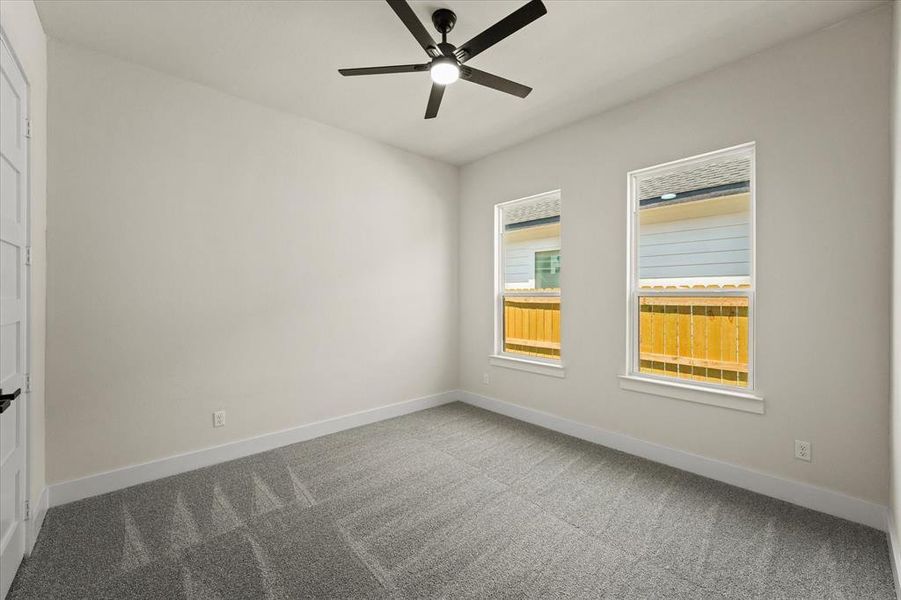 Unfurnished room featuring carpet floors and a ceiling fan Unfurnished room featuring carpet floors and a ceiling fan