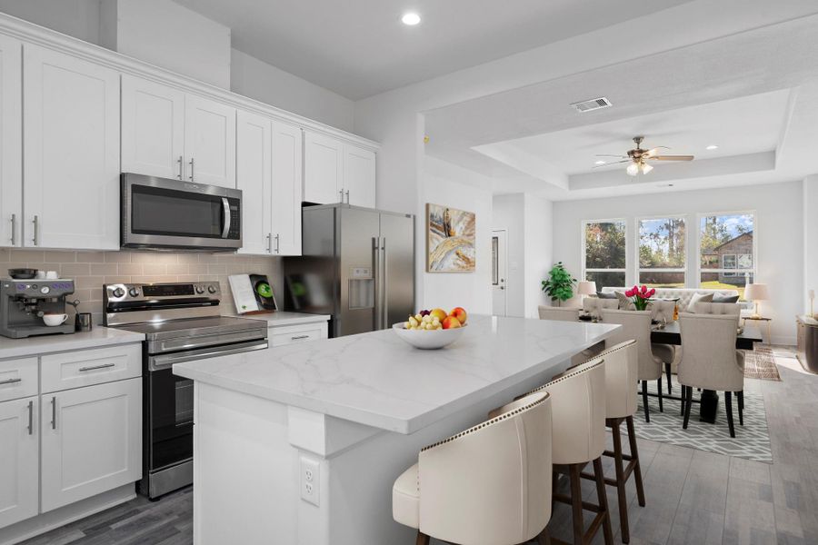 Virtually Staged: This open-concept floor plan seamlessly connects the kitchen, dining, and living areas, creating a bright and welcoming space perfect for everyday living and entertaining.