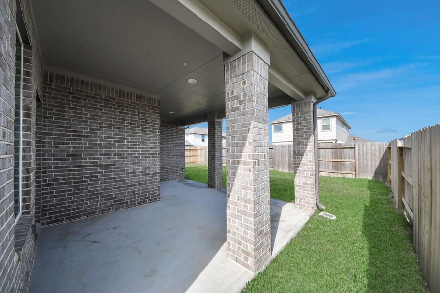 Experience outdoor living at its finest on this expansive covered patio, thoughtfully designed for BBQs and delightful outdoor dining.