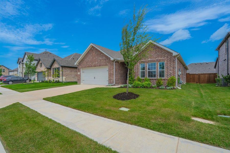 Front exterior of a new home in Devonshire, Forney, TX, highlighting curb appeal (Image 23). Front exterior of a new home in Devonshire, Forney, TX, highlighting curb appeal (Image 23).