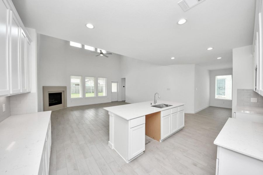 The open concept effortlessly connects the kitchen to the expansive family room, forming a perfect hub for gatherings. This seamless flow creates an inviting space where cooking and socializing come together harmoniously. Sample photo of completed home with similar floor plan. Actual colors and selections may vary.